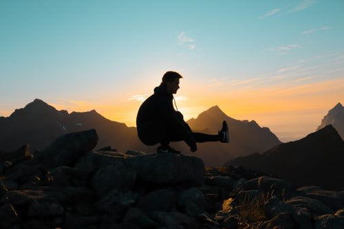 Man stretching with a sunset in the background: London Nootropics