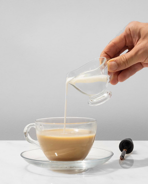 Pouring milk into a mushroom nootropic coffee