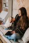 Pauline Cox drinking mushroom adaptogenic coffee and reading