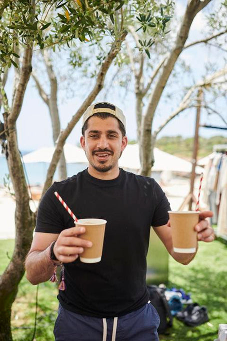 Man with two cups of mushroom coffee